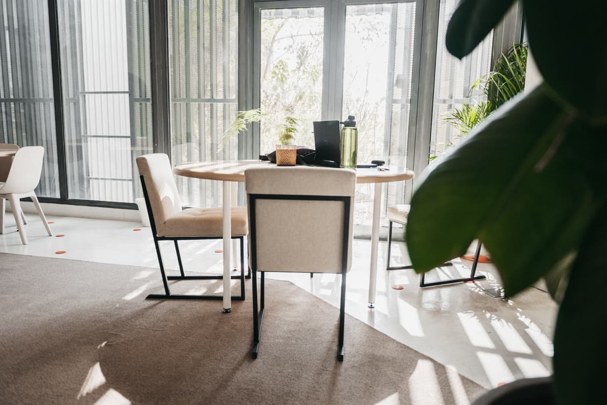 A corner table by MAZJ's tall windows in Al-Khobar, with daylight across the floor